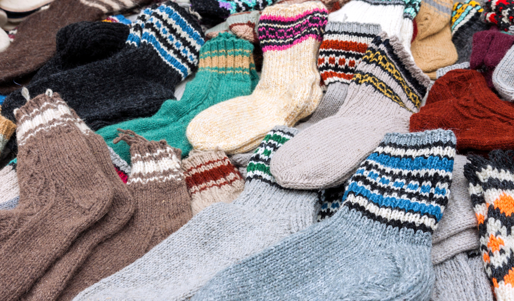 A pile of knitted colourful socks.